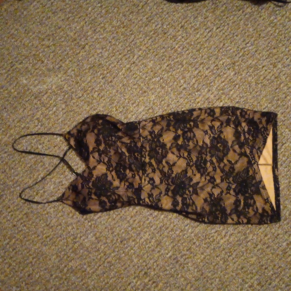 Black and nude lacy party dress. With criss cross straps.